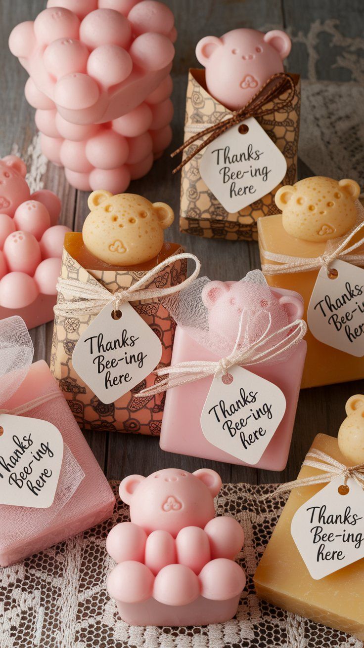 Collection of handmade soaps shaped like teddy bears and bubbles, wrapped with tags that say “Thanks Bee-ing here.” A charming party favor idea for a pink Winnie the Pooh baby shower with a honeybee twist.